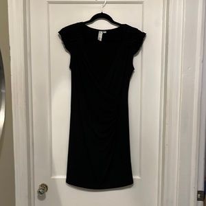 Little black dress with ruffled shoulder embellishments and plunging neckline